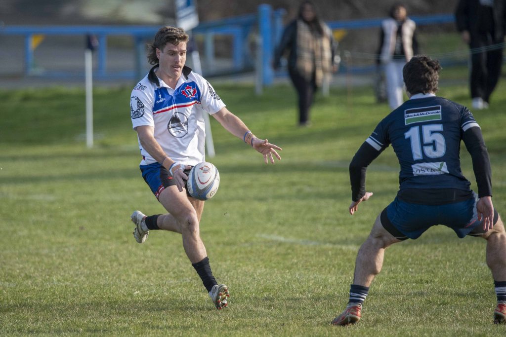 A Westshore player passing the ball off his hip as a defender closes, home game, February 2026.
